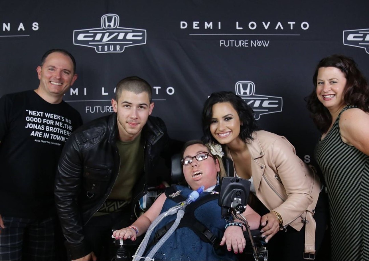 The Calise family, Michael, Corinna, and Michelle, with Nick Jonas and Demi Lovato 